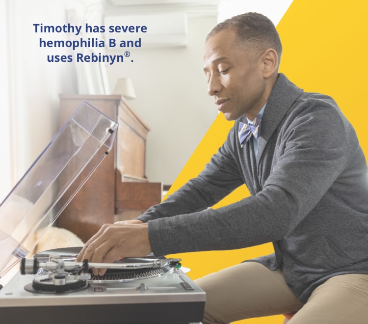 Image of a seated man using a record player.